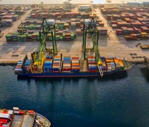 Aerial shot of colorful shipping containers at North Jakarta's bustling port, Indonesia.
